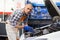 Positive man car mechanician repairing car in auto repair service