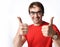 Positive man in red t-shirt and glasses show gestures thumbs up signs with both hands expressing luck, like, approved