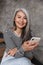 Positive mature woman sitting on steps