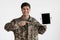 Positive military man showing digital tablet with empty screen