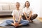 Positive millennial caucasian woman in sportswear and teenage daughter practice yoga, training