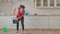 Positive mixed race woman mopping kitchen floor