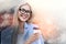 Always in positive mood! Close up portrait of cheerful business lady in suit holding cup of coffee and smiling while