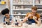 Positive multiethnic couple painting clay sculptures