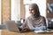 Positive muslim girl freelancer working at cafe