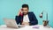 Positive office worker talking handset telephone sitting at laptop on his workplace, business conversation, break during work
