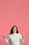 Positive Overweight Girl Pointing Fingers Upward Standing Over Pink Studio Background