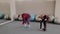Positive overweight woman and fit guy doing exercises while sitting on the floor. Funny learning