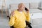 Positive pensioner talking on smartphone while