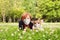 Positive portrait of woman and dog in medical mask outdoors 60 years old