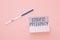 Positive pregnancy test and inscription ectopic pregnancy on sticker on pink background