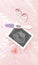 A positive pregnancy test and an ultrasound picture of a baby, a nipple on a pink background. Parenthood concept, birth