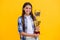 positive proud teen girl with champion cup award. teen girl hold her award champion cup isolated on yellow. teen girl