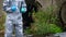 A positive reaction to the test results, a man in protective clothing, shows a good hand in a blue glove, against the drainpipes,