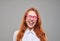 Positive red hair teenager girl laughing