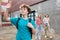 Positive school boy waving hand somebody