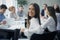 Positive secretary smiling to camera during meeting