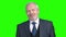 Positive senior businessman on green screen.