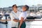 Positive Senior Couple Hugging Near Yachts At Marina Pier Outside