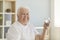 Positive senior man keeps healthy preventing dehydration by drinking enough water