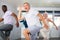 Positive senior man practicing vigorous dance during group class