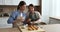 Positive senior mother and adult daughter in aprons decorating muffins