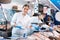 Positive shop assistants in work clothes posing in fish store