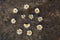 Positive smiley made of white daisies on a background of dark stone texture