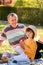 Positive smiling grandfather having fun during picnic