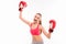 Positive sporty girl in boxing gloves triumphing