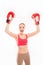 Positive sporty girl in boxing gloves triumphing