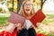 Positive student with glasses, funny posing with books holding t