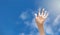 Positive symbol drawing by sunscreen sun cream, suntan lotion on caucasian open hand on blue sky background.
