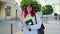 Positive teenage female student looking at camera waving hand, outdoor