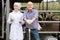 Positive veterinarian chatting with farmer