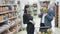 Positive video of young couple, woman makes funny face with fruits at supermarket