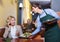 Positive waiter bringing order to happy charming mature female