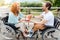 Positive wheelchaired couple holding a present
