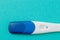 Positive White Plastic Pregnancy Test on blue  Background. - Image