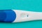 Positive White Plastic Pregnancy Test on blue  Background. - Image