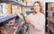 Positive woman buyer with assortment of grocery food store