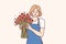 Positive woman flower seller stands with luxurious bouquet and smiling looks at camera