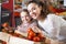 positive woman and little girl posing whith tomatoes in department fruits of store
