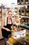 Positive woman standing with dried berries sold