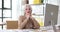 Positive woman worker leans head on hands sitting at table