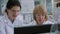 Positive women with goggles work on computer in laboratory