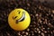 Positive yellow ball with a smile and coffee beans, good morning.