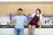 Positive young couple amusing while cleaning home together