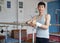 Positive young man asian acrobat posing at modern sport gym