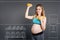 Positive young pregnant woman enjoying sport exercises.